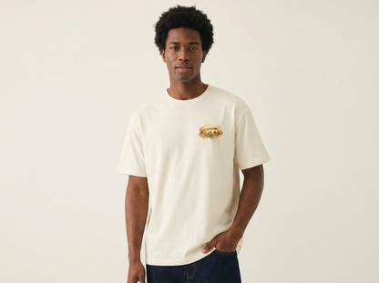Model wearing Jedidiah Philly Cheesesteak T-shirt front — watercolor cheesesteak illustration on natural cream unisex tee