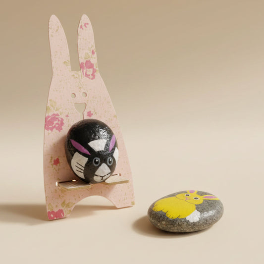 Decorative rabbit-shaped object with a small rabbit figurine inside, on a green cutting mat.